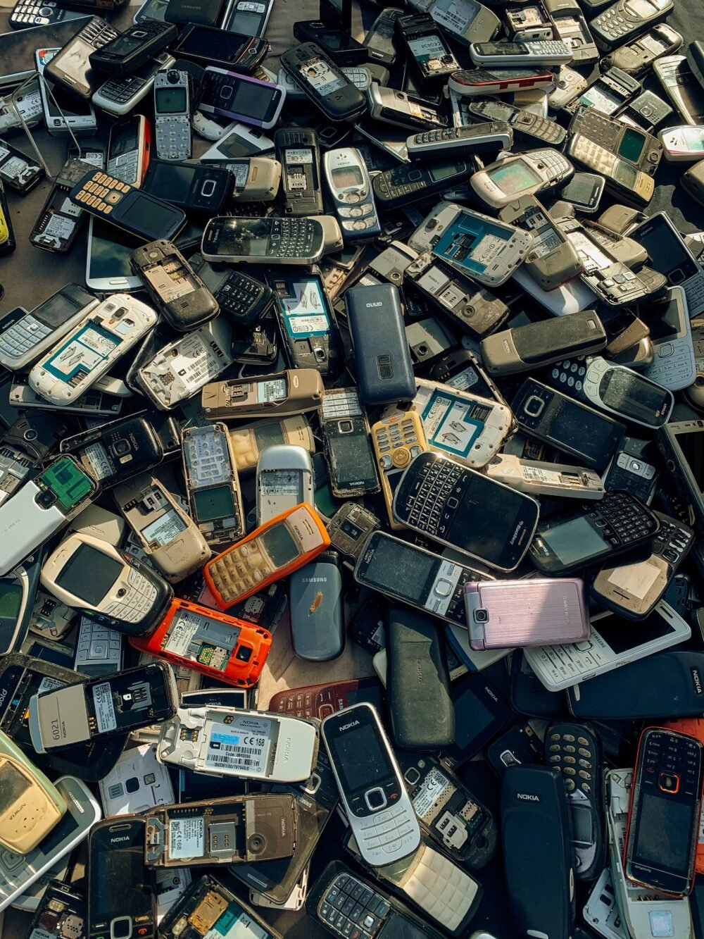 Pile of discarded mobile phones illustrating an article about cell phone radiation and radiofrequency RF exposure.