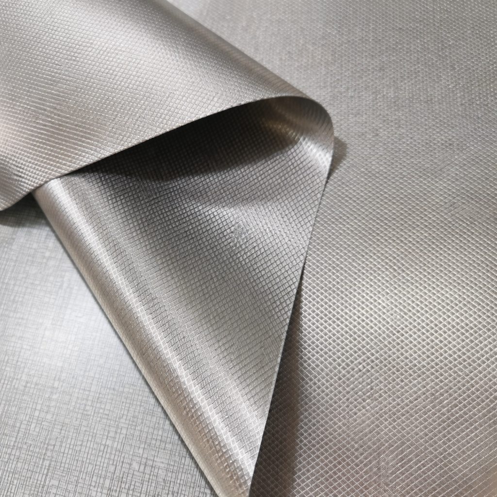 Military Grade EMF Shielding Fabric Close Up | Redemption Shield Close up of folded silver military grade EMF shielding fabric showing its conductive woven texture for RF shielding and Faraday protection products by Redemption Shield.