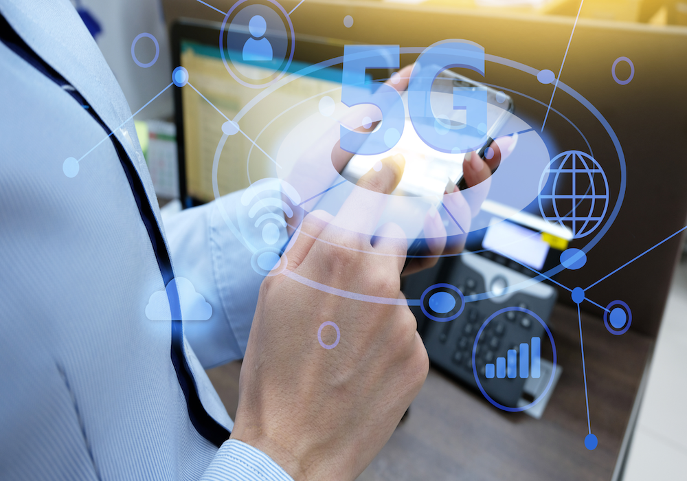 Balanced Technology: Supporting Wellness in a Connected World 9 Person holding a smartphone with a digital 5G network graphic, illustrating wireless technology and radiofrequency EMF exposure.