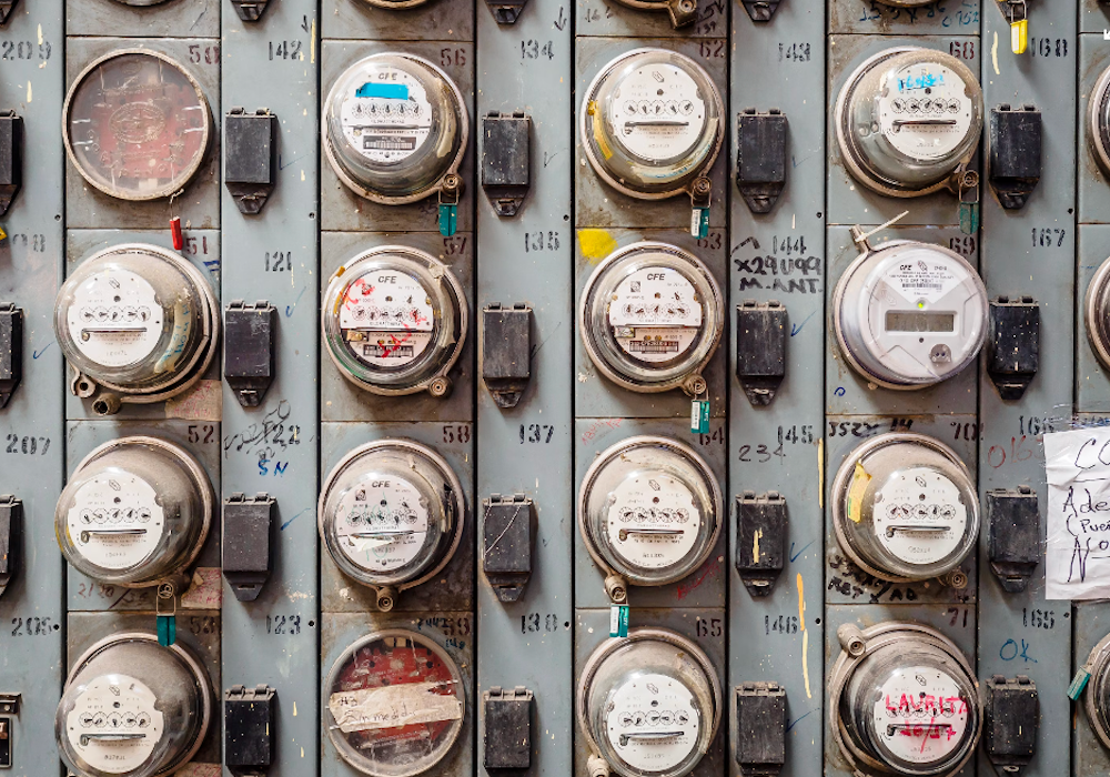 Do Smart Meters Emit EMF Radiation? The Truth Revealed 8 Rows of residential smart electricity meters illustrating smart meter RF signals and EMF exposure.